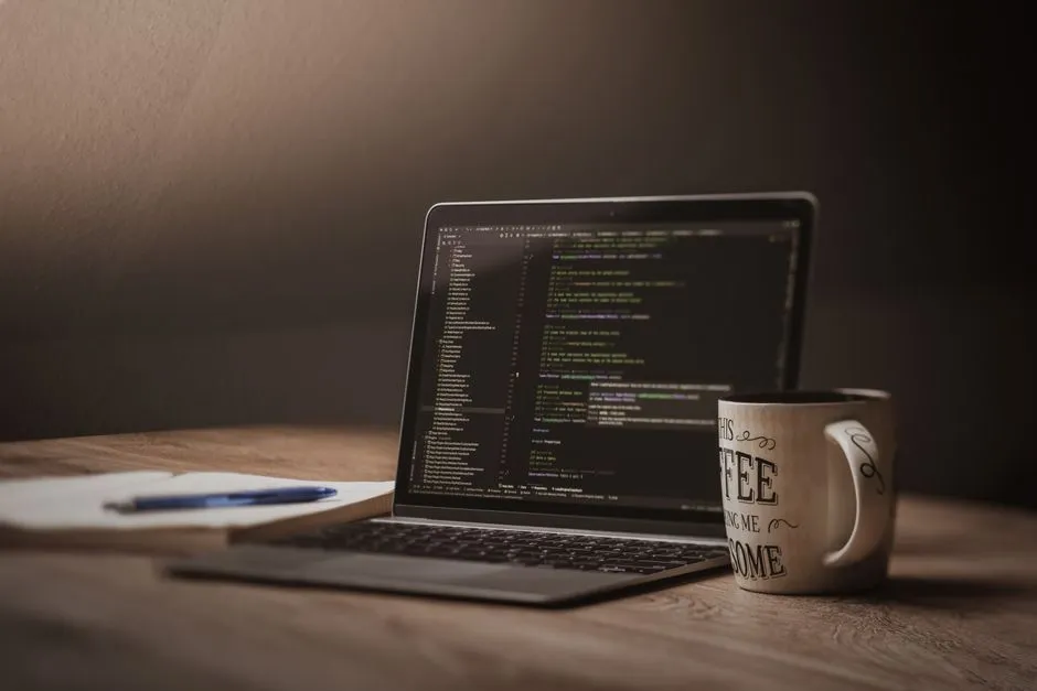 A cozy workspace with code displayed on a laptop screen